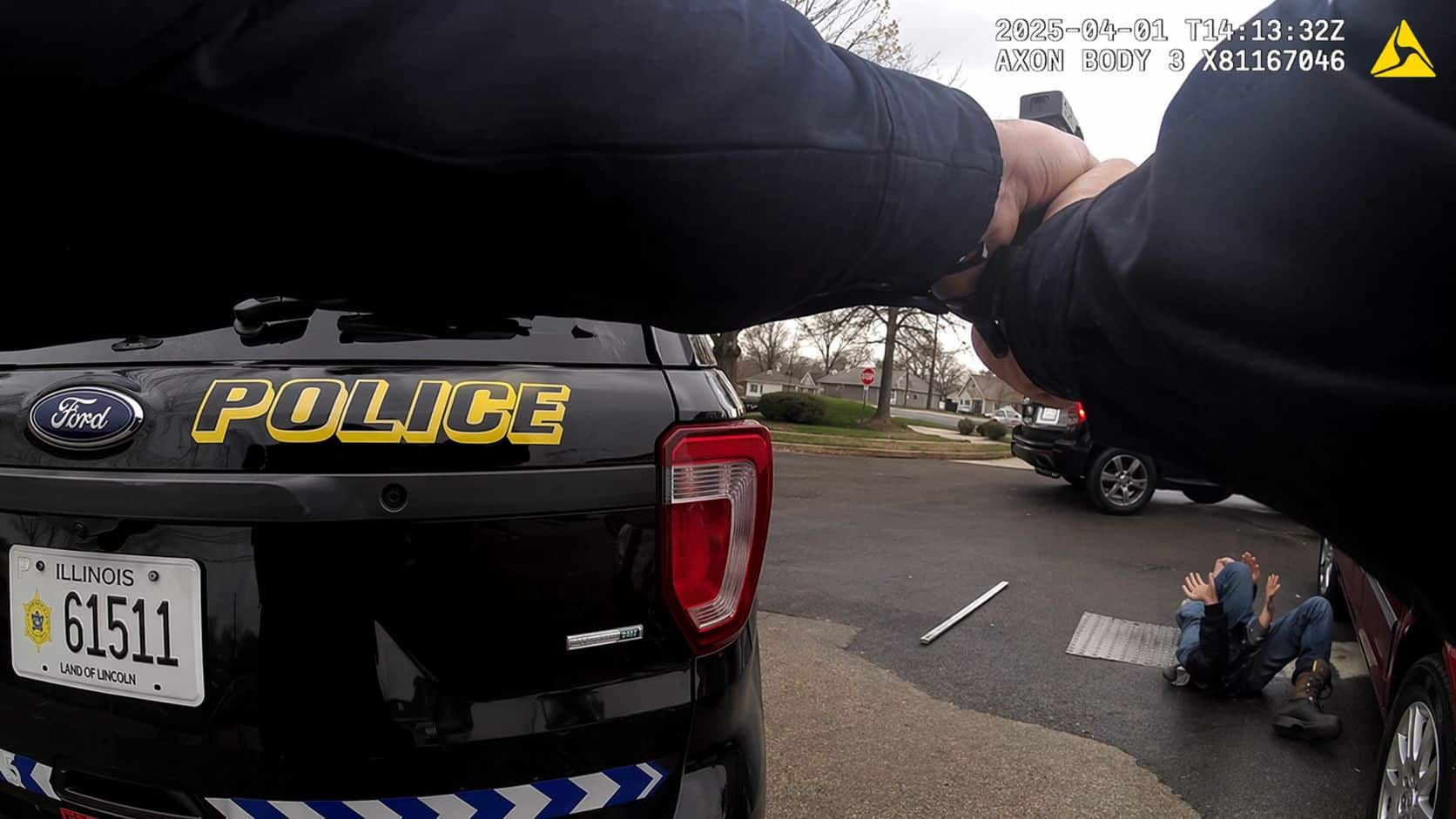 Police body camera still showing an officer beside a patrol car